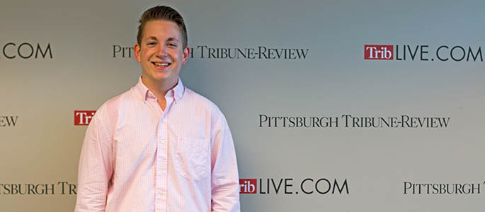 Pictured is School of Communication student Phillip Poupore at the Pittsburgh Tribune-Review. Photo | Victoria A. Mikula