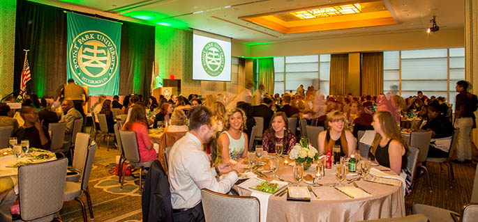 Students, faculty and staff dine at round tables in the banquet room of the Fairmont Pittsburgh hotel for the Outstanding Student Awards 2015. | Photo by John Altdorfer