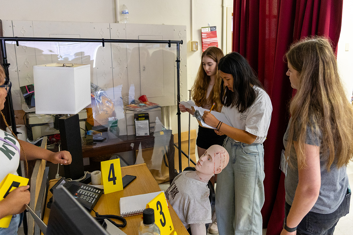 Students investigate a fictional crime scene at Point Park University.