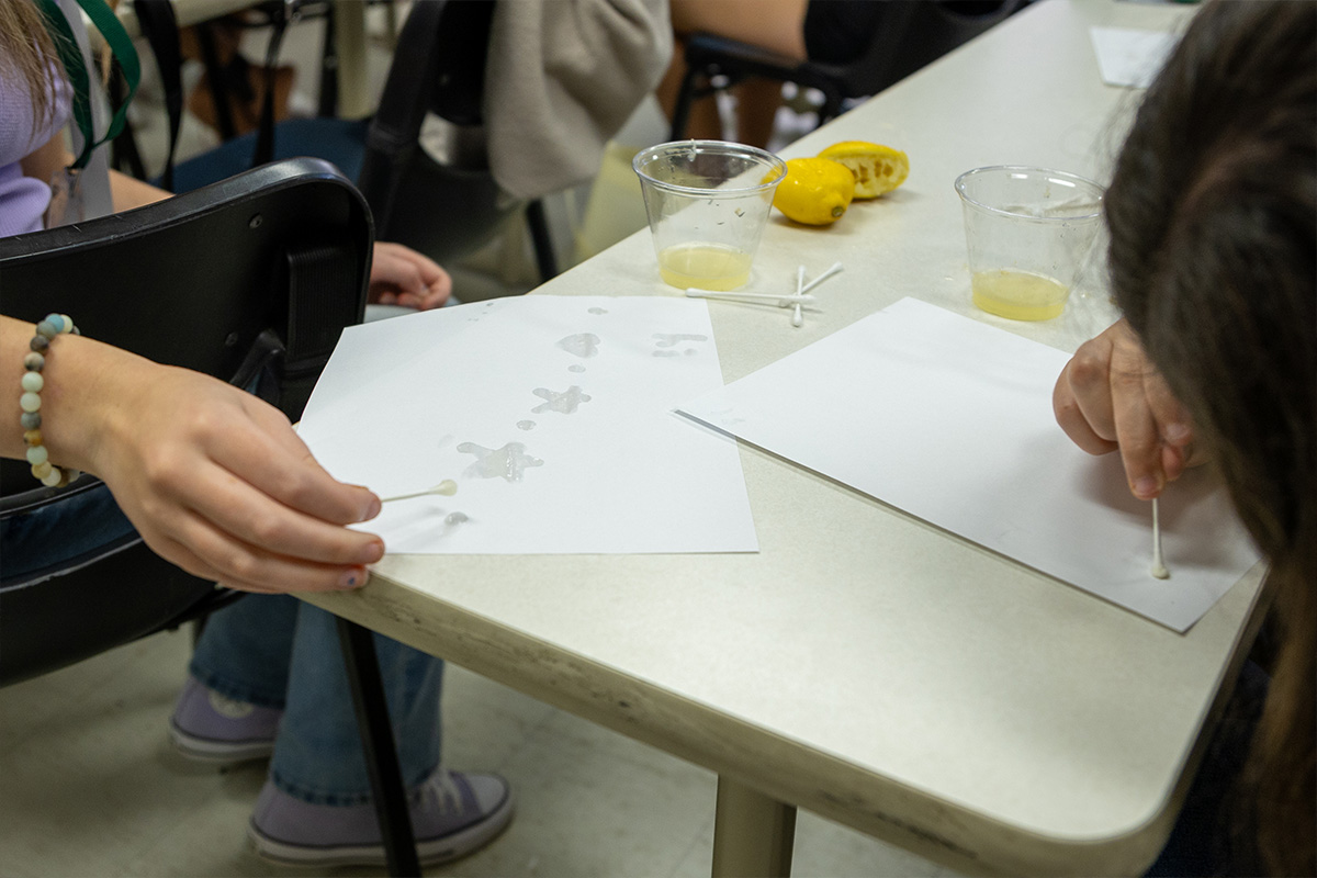 Students create hidden messages with lemon juice at Point Park University.