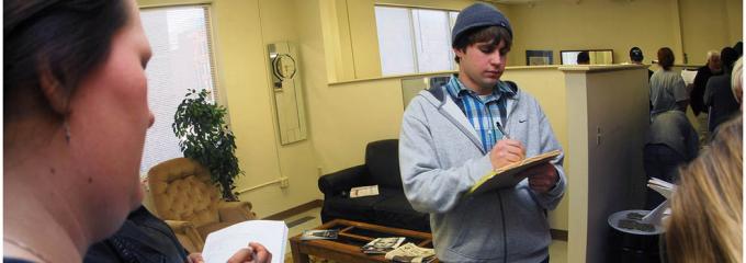 A Point Park University criminal justice student takes notes at a mock crime scene.