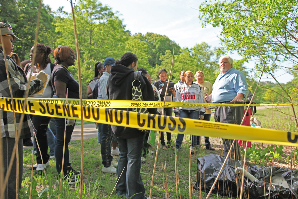 Edward Strimlan, M.D., visiting professor of forensic science, takes students on a field trip to Schenley Park, City of Pittsburgh, as part of a mock crime scene.