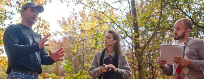 Students Mary Dindal and Jeff Mitchell shadow Brian Heap at the Pittsburgh Botanic Garden.