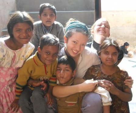 Pictured is global cultural studies alum Julia Franzen with children at an orphanage in India.
