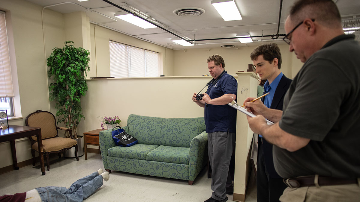 Pictured are members of the Hampton Township Citizens Police Academy at Point Park University's CSI House. Photo by Hannah Johnston.