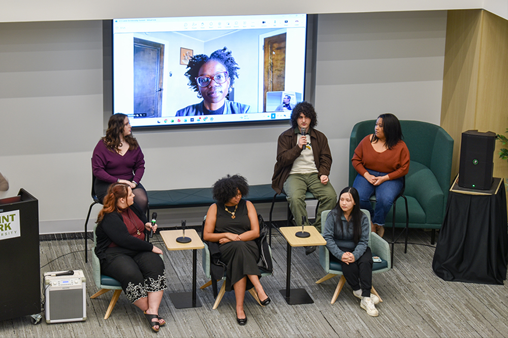 Students and alumni sit in the Career and Readiness Center at Point Park University as they discuss their careers.