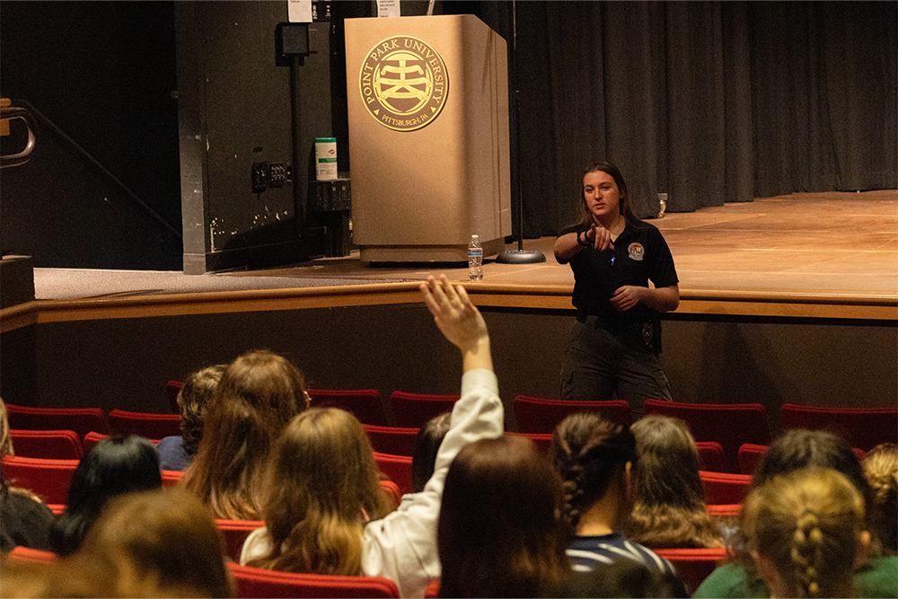 A student raises their hand as Jessica Weiber, a police officer from Ocean City, Maryland, points to them to answer a question.