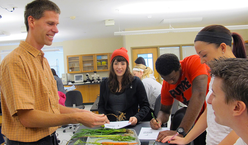 Pictured is Matthew Opdyke, Ph.D., teaching a botany class.