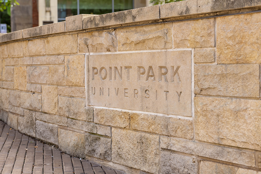 A brick wall displaying the Point Park University logo.