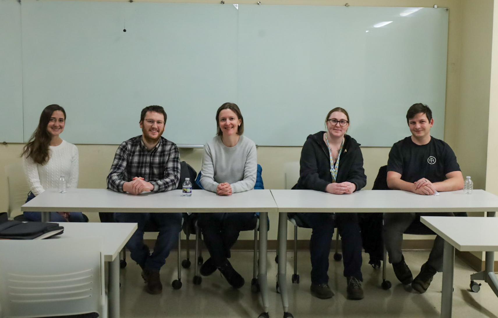 Pictured, from left to right, is Hannah Dollish, Brady Hasse, Masha Kaminsky, Laurel Dieckhaus, Michael Cardenas. They are sitting in one of Point Park University's labs in front of a whiteboard.