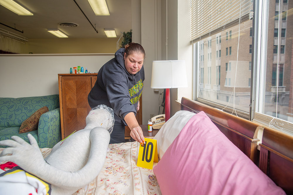Pictured is a student setting up a mock crime scene in the CSI House. Photo by Randall Coleman.