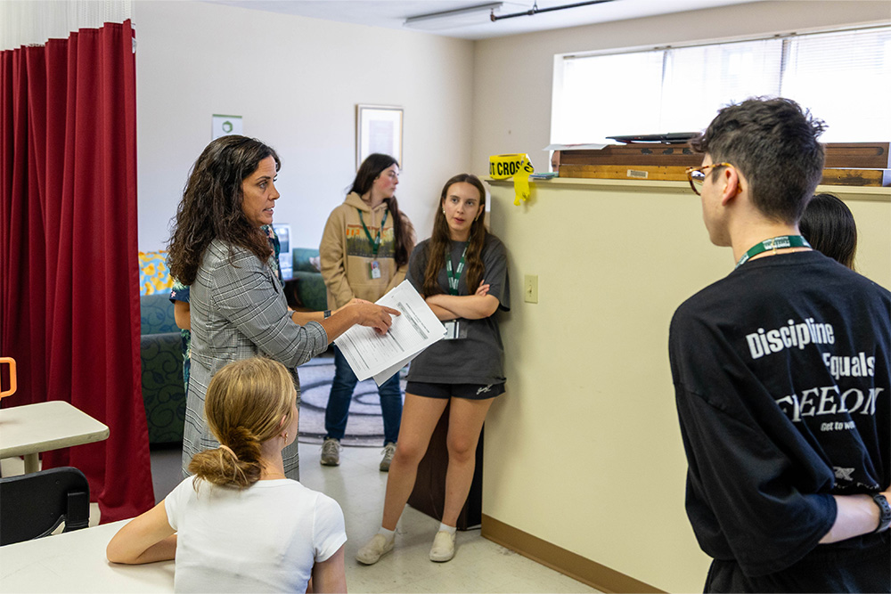Pictured is Christine Secilia lecturing to highschool students at one of Point Park Unviersity's summer camps in 2025.