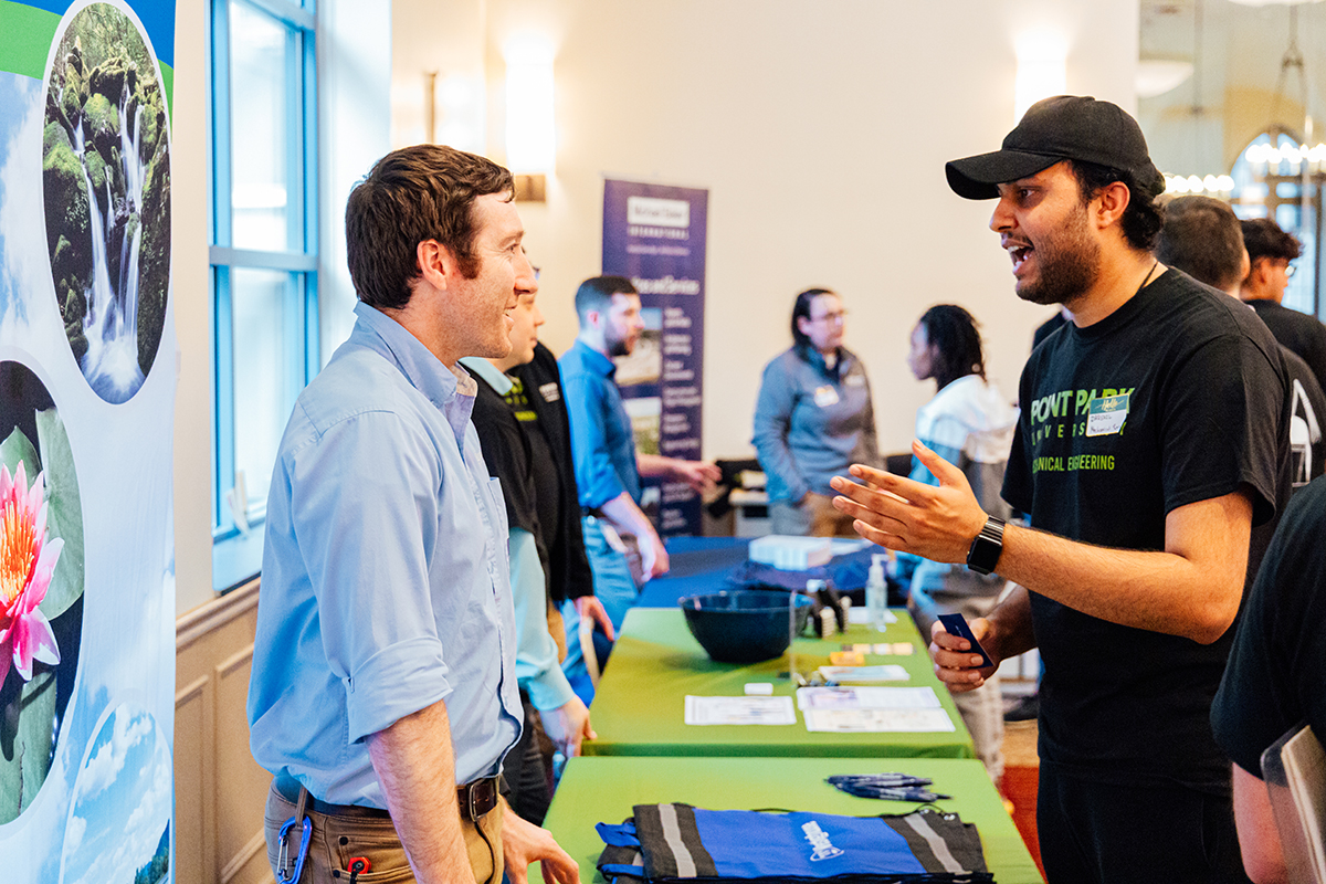 Pictured is Darshil Patel speaking to a representative from Westinghouse. Photo by Ethan Stoner.