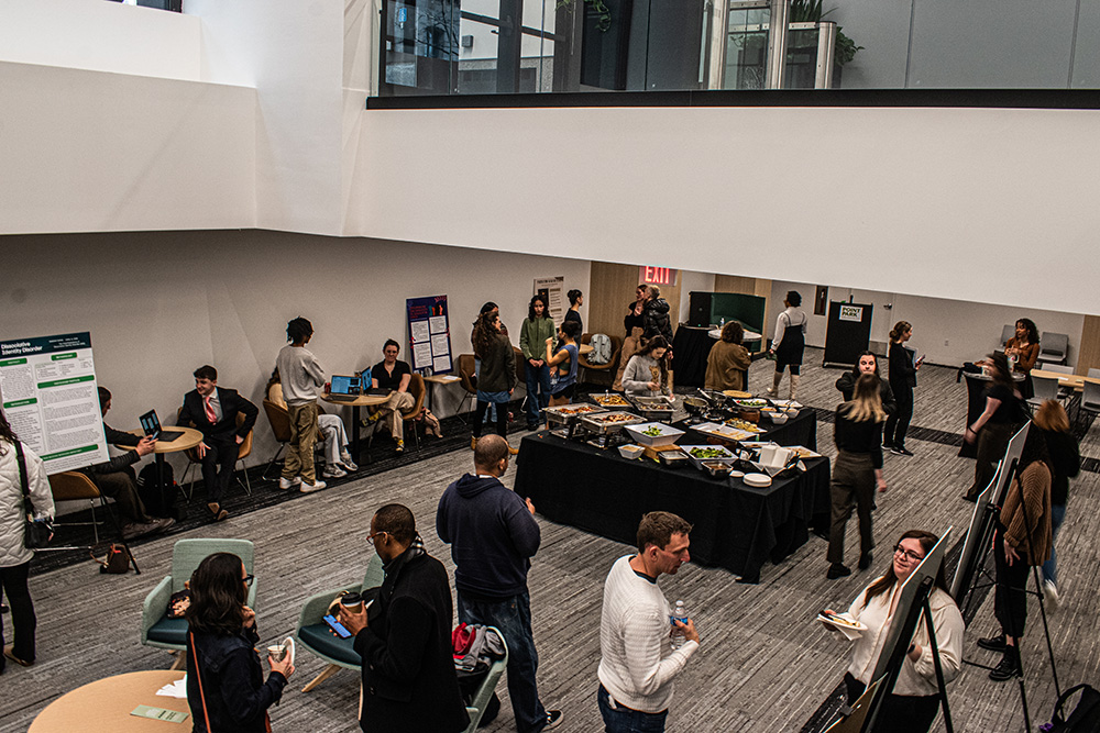 Pictured are students and faculty at the spring symposium in the Professional Career-Readiness Center. Photo by Angelina Caceres.