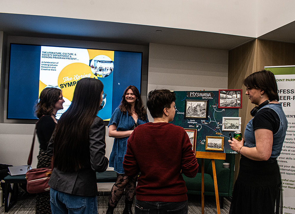 Pictured are students and faculty at the spring symposium in the Professional Career-Readiness Center. Photo by Angelina Caceres.