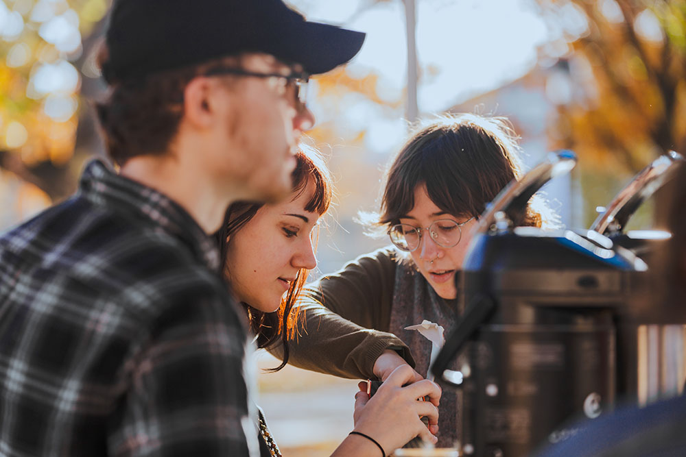 Pictured are psychology students Sam Spano, Kay Karlie and Bridget McCarthy preparing coffee at a Mobile Thriving Respite event. Photo by Ethan Stoner.