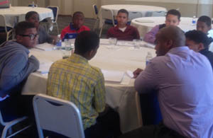 Pictured are middle school students in the BOLD program meeting with their BOLD mentor. | Photo by Herman Reid, Ed.D.