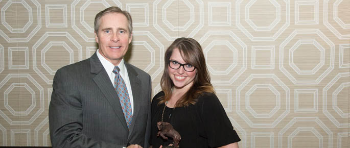 Pictured is 2014 sports, arts and entertainment management alumna Chelsey Behanna with President Paul Hennigan. | Photo by John Altdorfer