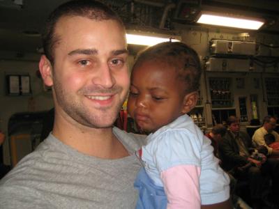 Point Park student Herbie Pallotta holds a Haitian girl who was among 54 orphans flown to Pittsburgh