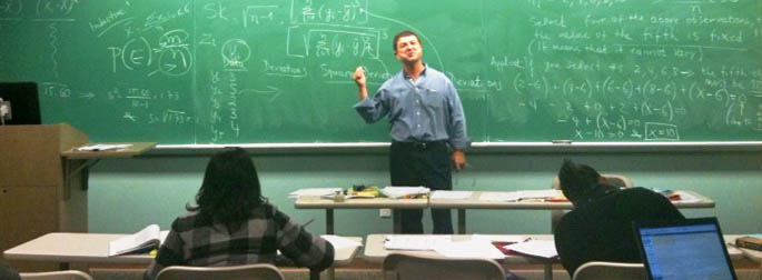 Pictured is Dimitris J. Kraniou, Ph.D., teaching an M.B.A. class.
