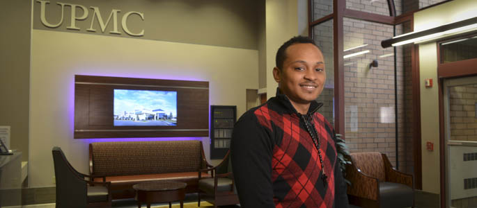 Pictured is Mychael Lee, 2014 M.A. organizational leadership alumnus and senior HR assistant for the UPMC Center for Engagement and Inclusion. | Photo by Jim Judkis
