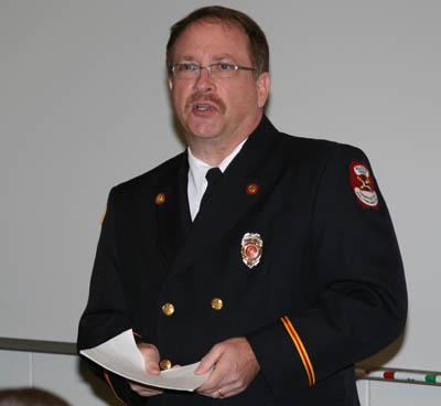 Pictured is Robert Skertich, Ph.D., assistant professor of public administration and director of nontraditional business programs at Point Park, giving a commencement address at Pittsburgh International Airport. | Photo by Brian Colella