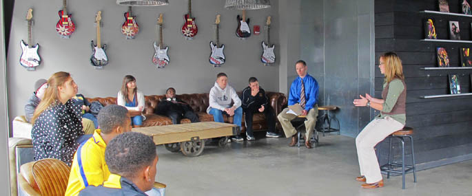 Assistant Professor David Rowell, M.F.A., is talking with high school students at Stage AE.