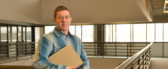 Pictured is information technology alum William Constant at FiServ. | Photo by Jim Judkis
