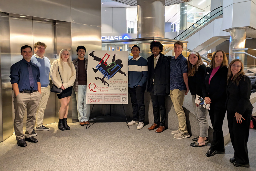 Accounting students from Point Park University pose near a sign for Enron by Lucy Prebble.