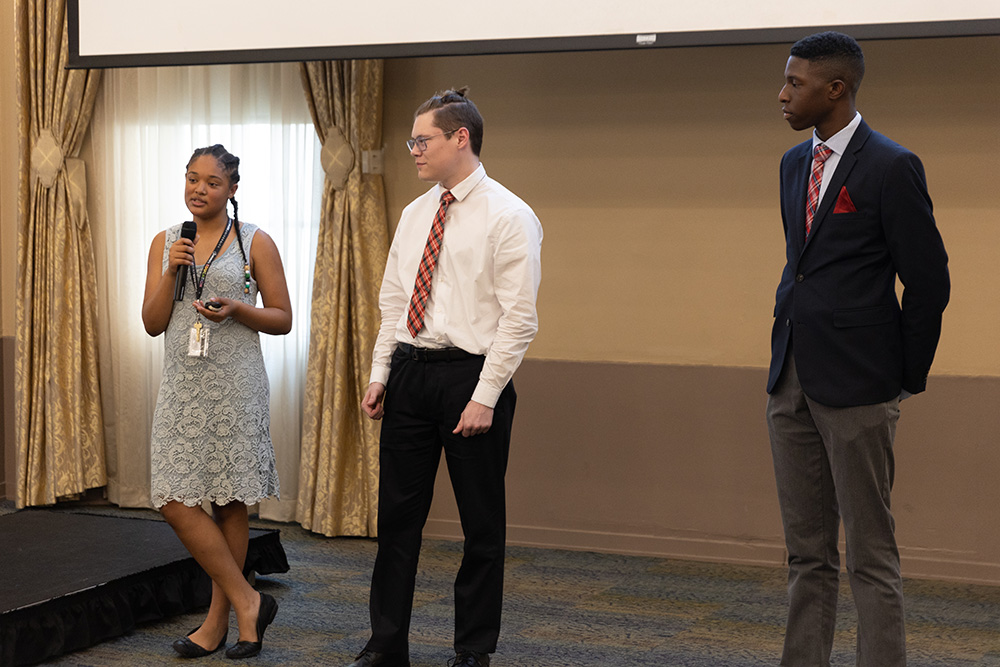 Three students deliver a presentation on Gout de la Maison, the business they developed during ACAP. Photo by John Altdorfer.