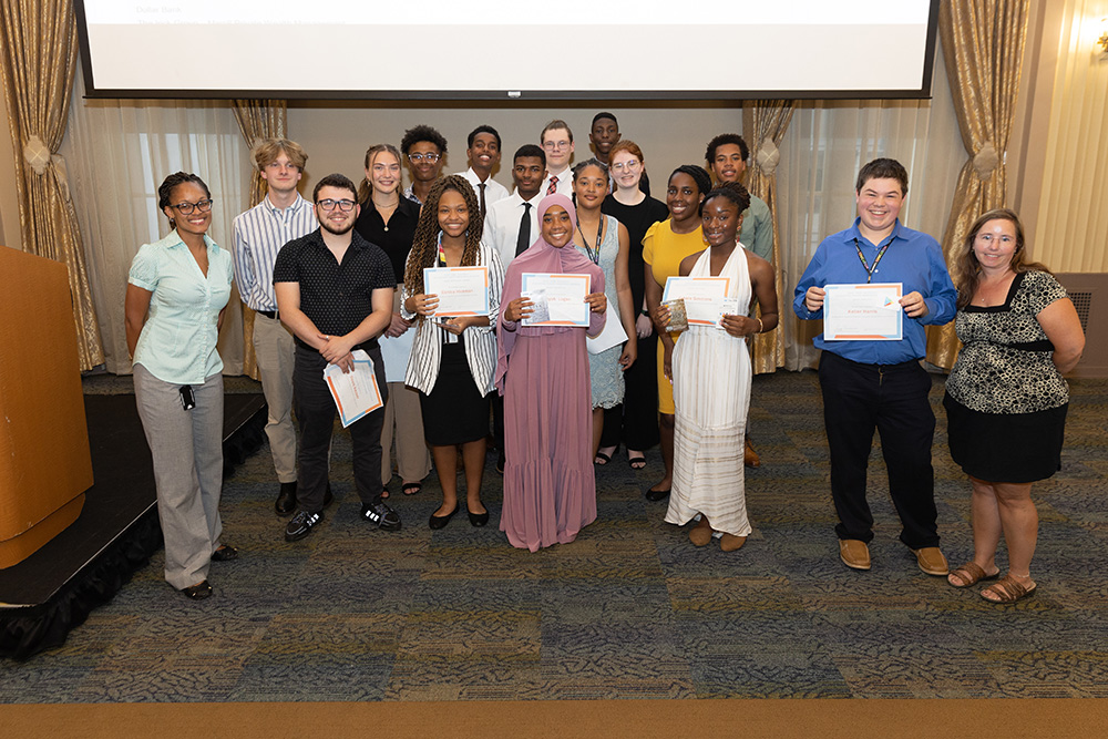 Pictured are Brittney Arnett, recruiter and community outreach coordinator, far left, and Professor Amy Cesario, far right, with the 2022 ACAP students. Photo by John Altdorfer.