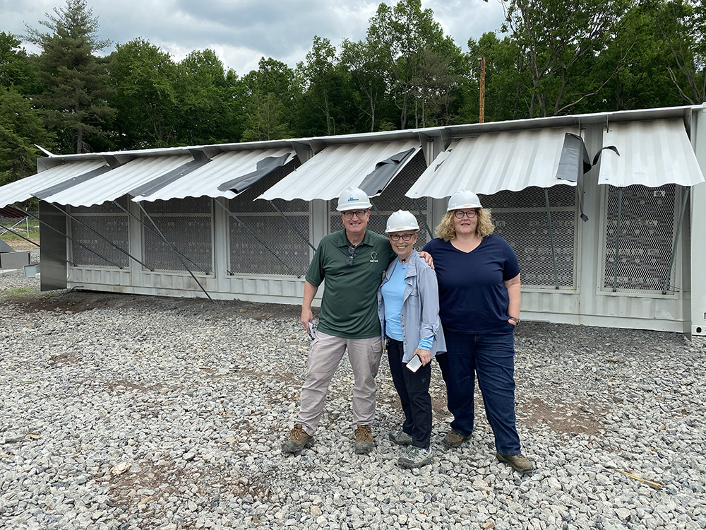 At the Scrubgrass Power Plant, hundreds of Bitcoin miner machines are housed in upcycled shipping containers. Pictured from right to left are faculty members Lee Sullenger, Angela Isaac and Cheryl Clark in front of some of the shipping containers.