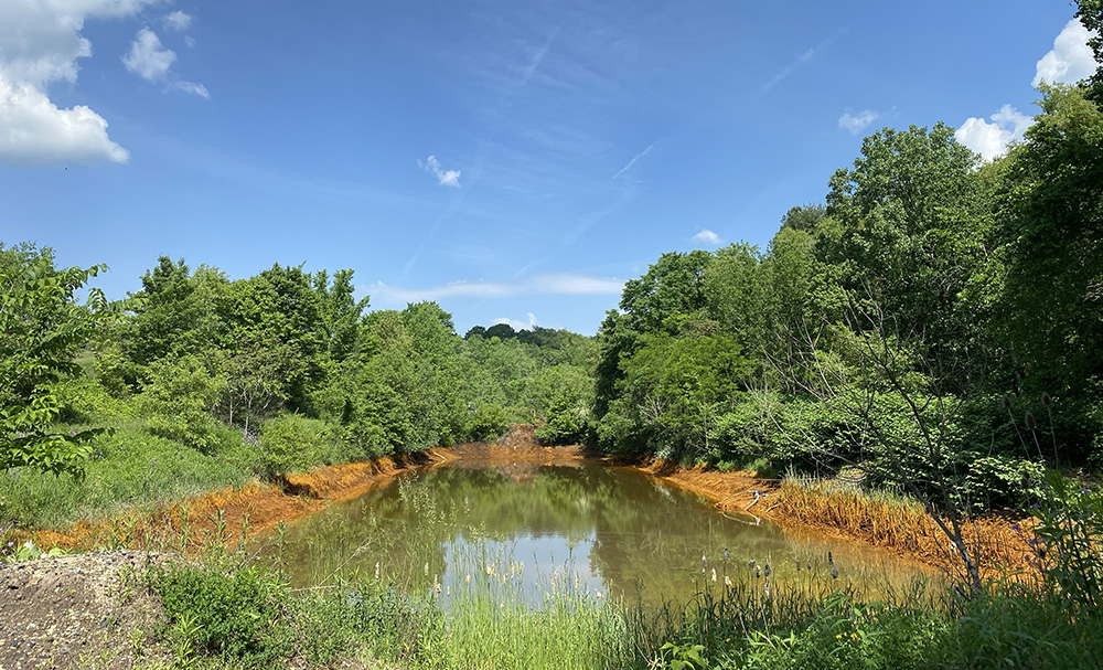 Pictured is a body of water that is being decontaminated by Stronghold Digital Mining's coal reclamation operation.