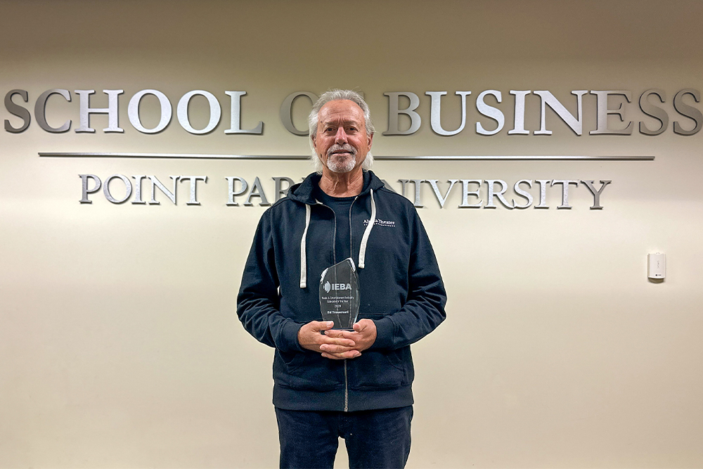 Pictured is Ed Traversari, a Point park University professor, with the IEBA Music and Entertainment Industry Educator of the Year award.