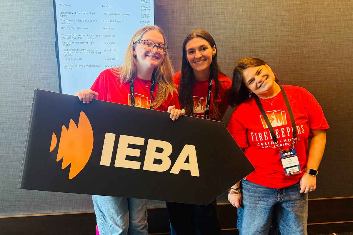 Students pose with a sign at the 2026 IEBA Conference.