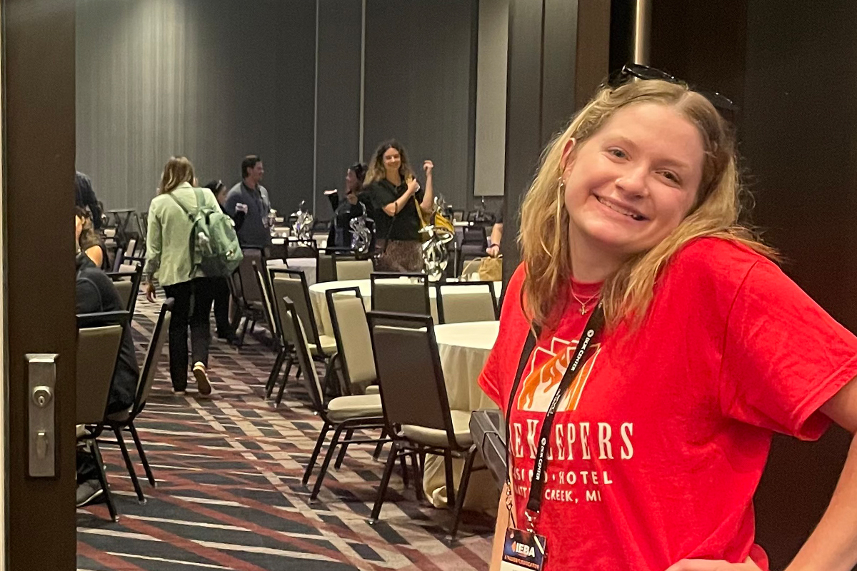 A student poses outside a conference room at the 2026 IEBA Conference.