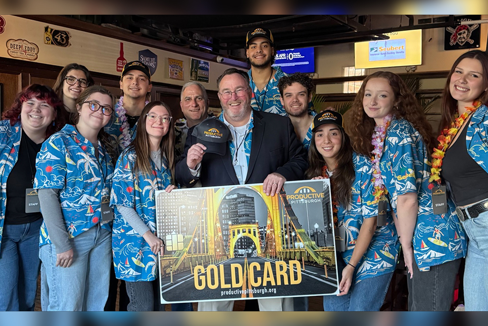 Students pose with a sign for Productive Pittsburgh's Gold Card. 