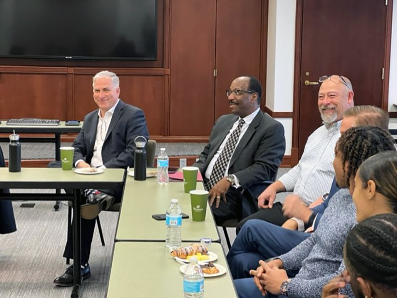 Pictured from left are Steve Tanzilli, dean of the Rowland School of Business, and Mitchel Nickols, Ph.D., director of Rising Brothers and Sisters, at a business breakfast with the Bank of America Black Professional Group and The Irick Group..