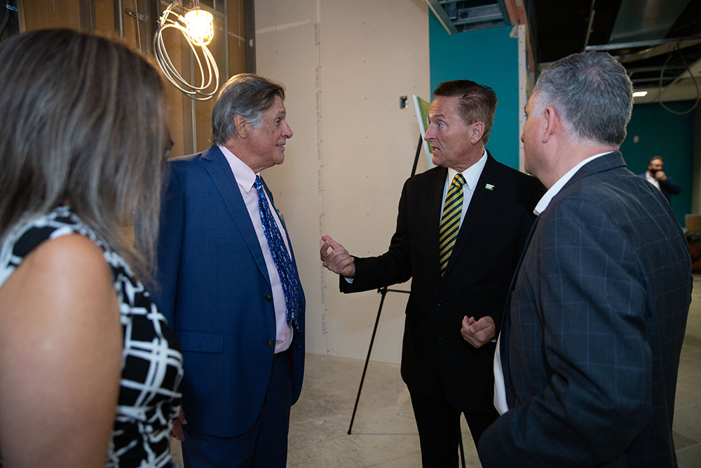 Michael P. Pitterich, second from left, speaks with President Donald Green, second from right. Photos by  John Altdorfer.