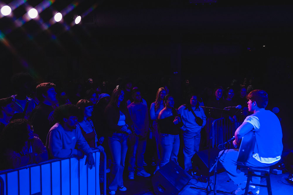 A man plays guitar on a stage.
