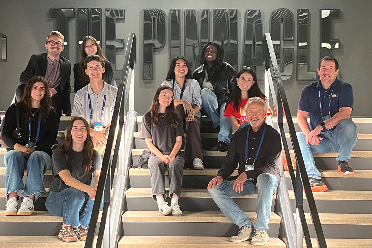 Students posing for group photos at several spots at the Pinnacle.