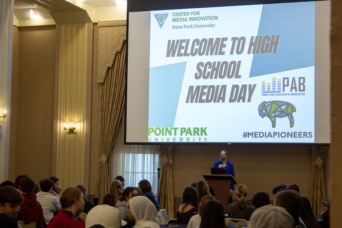 Graduate Assistant Casey Hoolahan welcomes High School Media Day participants. Photo | Natalie Caine