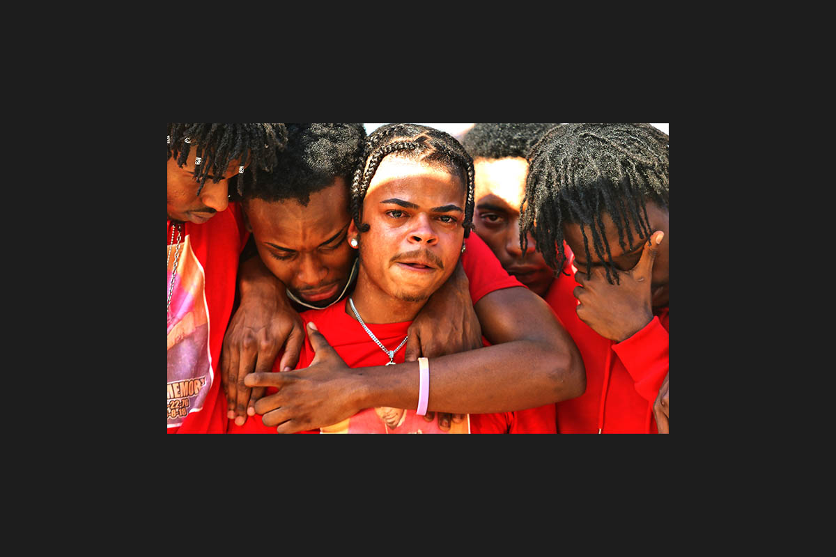 Shaheen Mackey, Jr., center, is consoled by supporters in front of the Luzerne County Courthouse in Wilkes-Barre, Pa Sunday, August 9, 2020.  The friends embraced during a Black Lives Matter rally in support of Mackey's father, Shaheen Mackey, a Luzerne County Correctional Facility inmate who died in 2018. Sean McKeag/ The Citizens' Voice