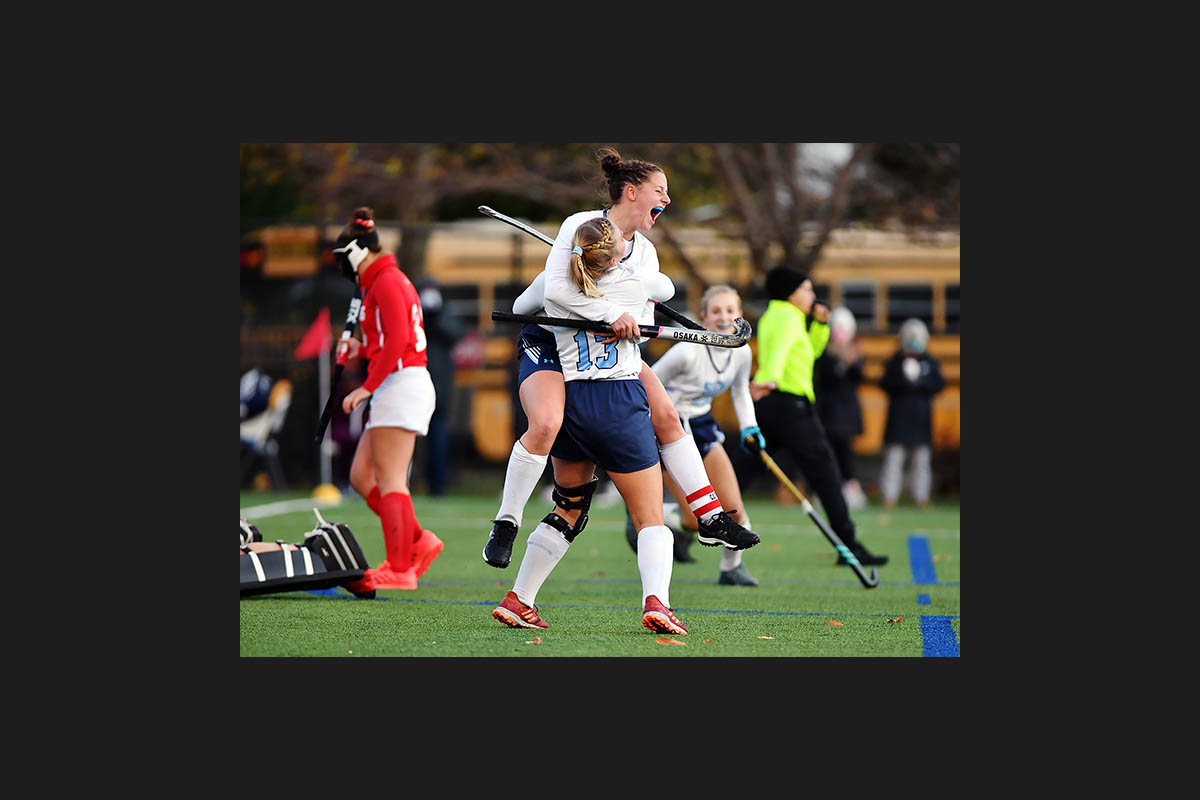 Wyoming Seminary’s Grace Parsons leaps into the arms of Maddie Olshemski (13) after Olshemski scored a goal against Bloomsburg during the PIAA Class 1A field hockey semifinals at Wyoming Seminary’s Klassner Field in Kingston Tuesday, November 17, 2020. Photo | Sean McKeag