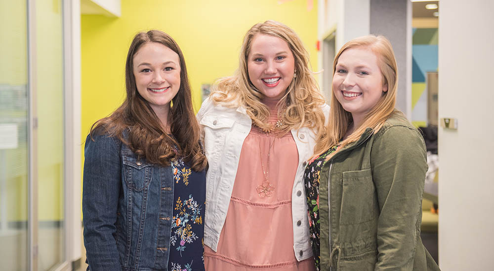 Alumnae Lauren Joseph, Maggie McCauley and Caite Miller in the Center for Media Innovation. Photo | Nick Koehler