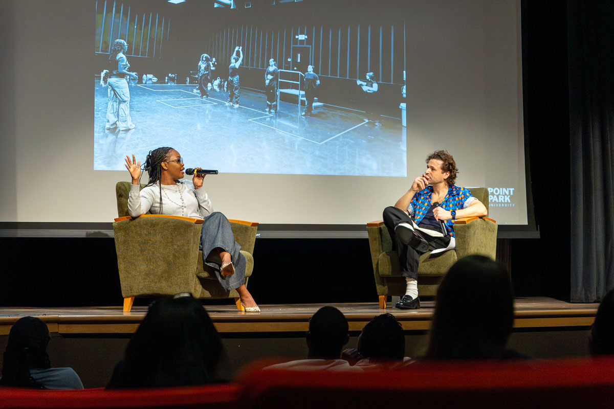 Charm La'Donna and Christopher Pandolfi talk on the stage. 