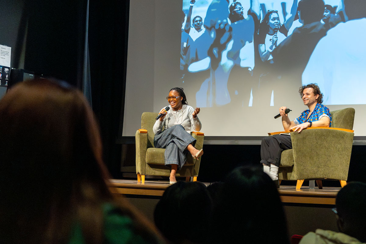 Charm La'Donna and Chris Pandolfi talk on the stage. 