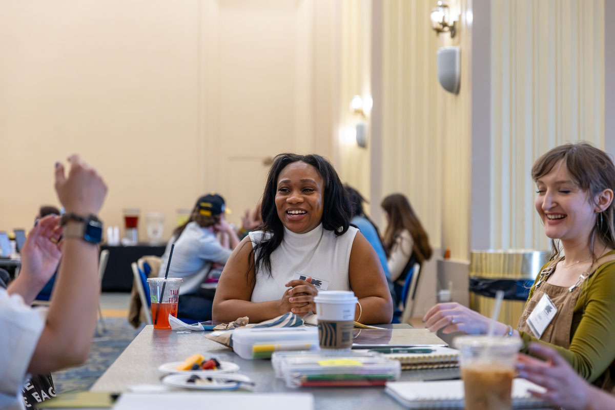 Alexus Matayer talks at a table with her small group.