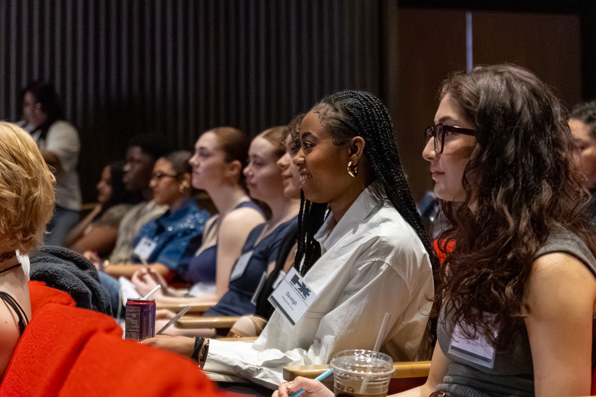 Students sitting in a theatre listening to Charm La'Donna.