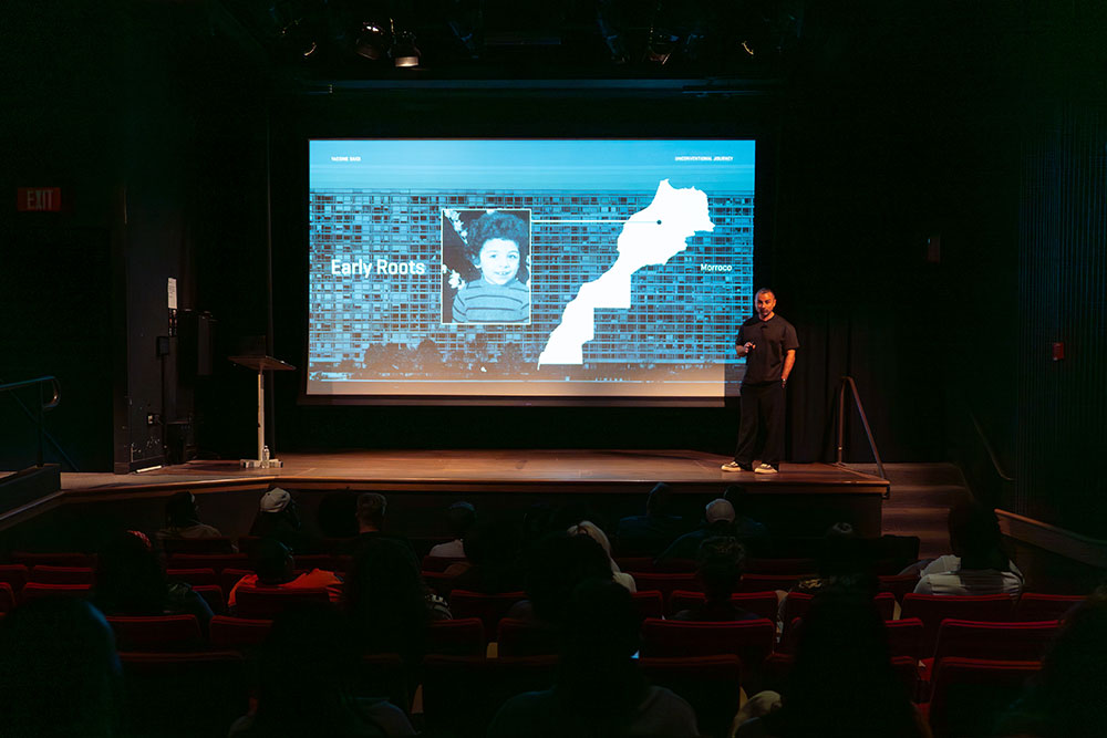 Yassine Saidi presents on the stage.